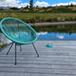 single pet bowl, matching collar chair on deck, pond grass and blue sky in background